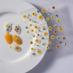 Detail of 3D summer sunflower and honeybee nail art stickers with sample manicure