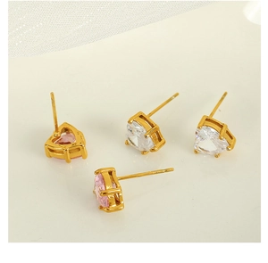 Detailed view of heart-shaped earrings with pink and white cubic zirconia in gold plating