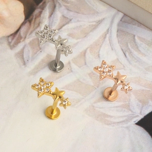 Star-shaped stainless steel ear and lip studs with sparkling crystals in three metallic colors
