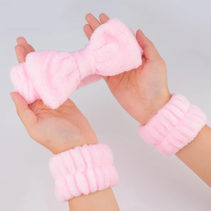 Pink coral fleece spa set with bow headband and matching wristbands for face washing