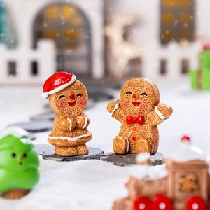 Miniature resin Christmas gingerbread man figurines in a snowy DIY holiday scene