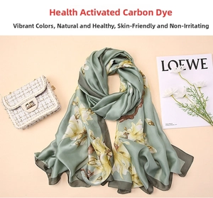 Detail of silk-like long scarf in bean green with elegant white magnolia floral print