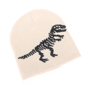 Detailed view of cream knit beanie featuring black dinosaur skeleton jacquard pattern
