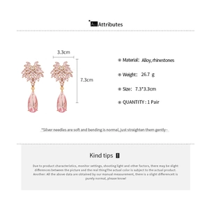 Detailed view of pink rhinestone flower earrings with alloy base and size dimensions