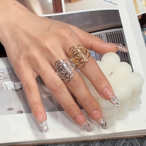 Hollow out rose rings in gold and silver finish on a stylish magazine background