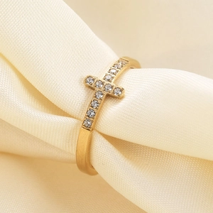 7mm gold stainless steel cross ring with sparkling zircon stones on silk background