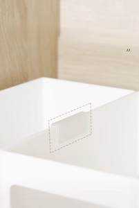 Close-up of white matte drawer organizer with U-shaped clip for secure labeling and stability