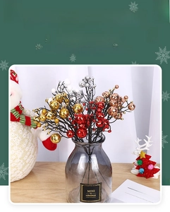 Detail of glittered Christmas berry stems in gold and silver for holiday decor