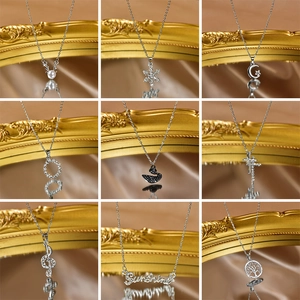 Collection of nine stylish stainless steel pendant necklaces including star and moon motifs