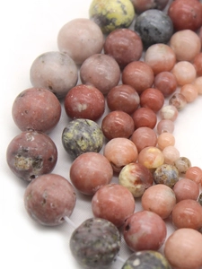 Close-up of mixed natural plum blossom jade round beads for DIY jewelry making