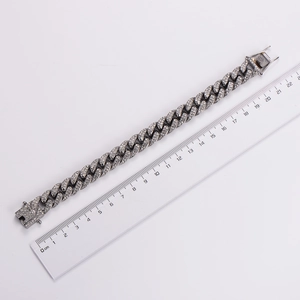 Measuring polished silver Cuban link bracelet with sparkling rhinestones, 21cm length