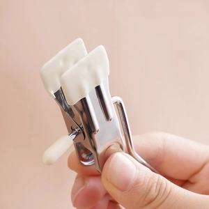 Handheld silver stainless steel spring clip with white anti-slip silicone pads for clothing