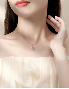 Detailed view of S925 silver moissanite heart necklace in rose gold on a female model
