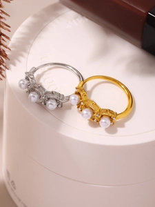 Close-up of vintage adjustable open rings with white pearls and sparkling cubic zirconia