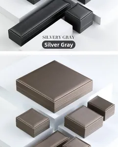 Detailed view of brushed silvery gray jewelry box collection on white geometric steps