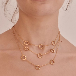 Close-up of triple-layered 18K gold plated minimalist necklace with round loop accents