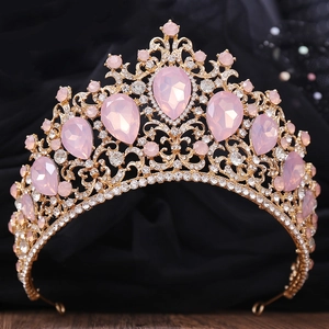 Golden Baroque crown with pink teardrop crystals and sparkling rhinestones on black velvet