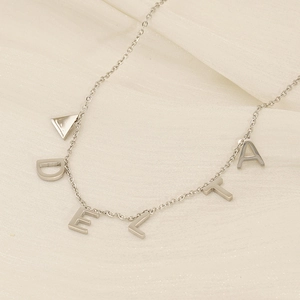 Polished silver titanium steel necklace featuring DELTA letter pendants on silk fabric