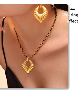 Wearing effect of golden shell jewelry set with braided chain and heart accents