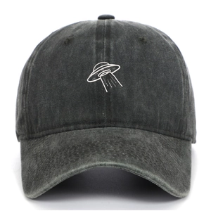 Detail of UFO embroidery on washed vintage gray cotton baseball cap with retro finish