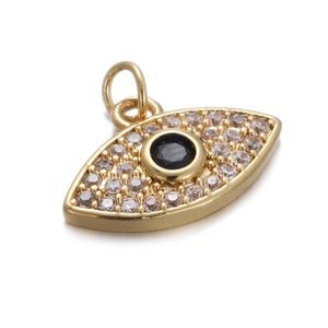 Macro shot of gold Evil Eye pendant with clear zircon pave and black center stone
