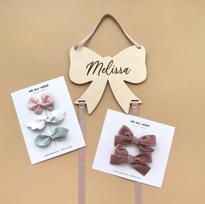 Detail of leather and velvet hair bows set with a custom wooden Melissa bow holder