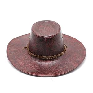 Detail of red-brown cowboy hat featuring leaf vein embossing and braided rope band