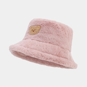 Close-up of pink plush bucket hat featuring a cute brown bear embroidery detail