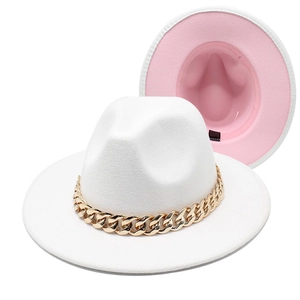Detail of fedora hat with large gold acrylic chain and pink two-tone lining