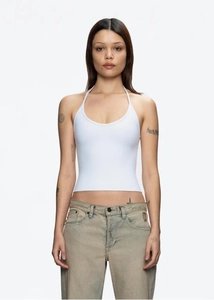 Detailed view of the white halter neck tank top featuring slim fit ribbed knit material