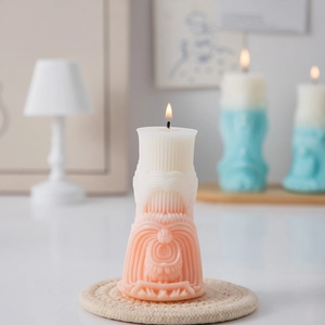 Detail of creative Roman column candle showing pink gradient texture and relief pattern