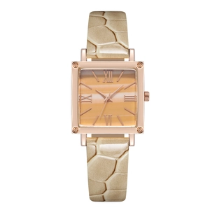 Macro detail of square rose gold watch case with gradient orange dial and beige leather strap