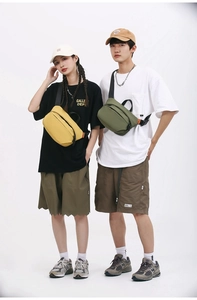 Detail of large nylon crossbody bags in lemon yellow and olive green for street style