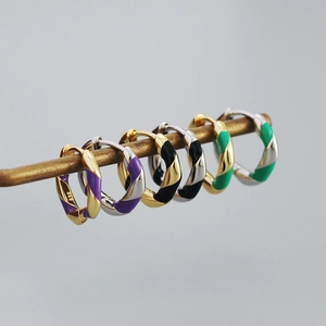 Close-up of colorful enamel twisted hoop earrings with 925 silver hallmarks on the inner band