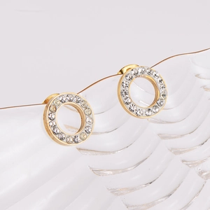 Elegant gold-tone circular rhinestone earrings with white enamel on textured glass base