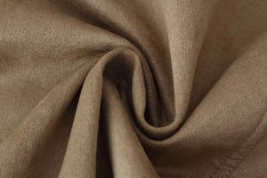 Macro shot of brown suede jacket fabric showing soft texture and fine fiber details