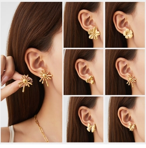 Detail view of vintage gold stainless steel earrings in flower and bow shapes