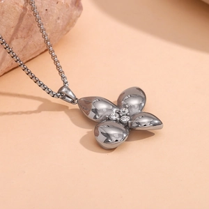 Detailed view of silver flower pendant with clear crystals on a delicate metal chain