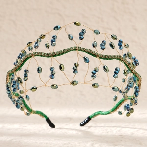 Detailed craftsmanship of gold bridal headband with green and blue crystal bead weaving