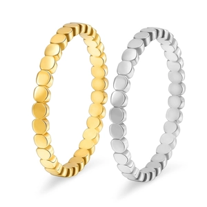 Detail of minimalist 18K gold and silver bubble textured rings for stackable wear