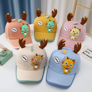 Detail showing colorful baby baseball hats with cute cartoon dragon and plush deer antlers