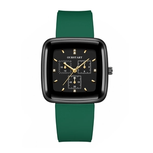 Macro shot of a square black watch face with gold hands and a dark green silicone strap