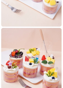 Detailed view of assorted artificial mousse cup cakes with lifelike cream and fruit toppings