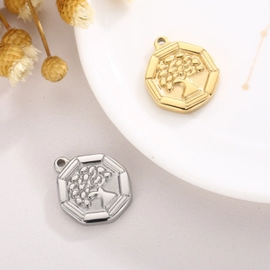 Golden and silver tree of life hexagon pendants in a minimalist street style display