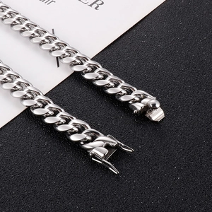 Detailed close-up of a silver stainless steel Cuban link chain with a secure box clasp