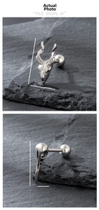 Macro shot of Gothic sheep and bird skull earrings with specific size dimensions