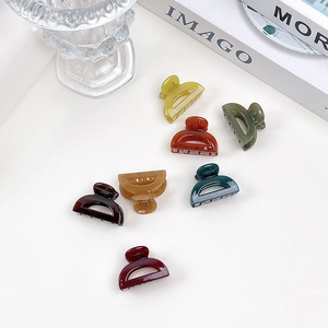 Flat lay detail of minimalist jelly texture hair clips in assorted vibrant colors