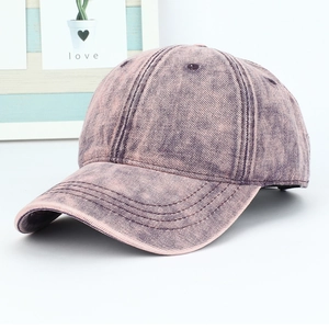 Close-up of vintage washed pink cotton baseball cap showing detailed stitching and fabric