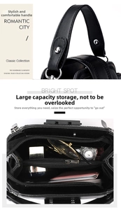 Detail of the black leather handbag showing the sturdy handle and spacious interior