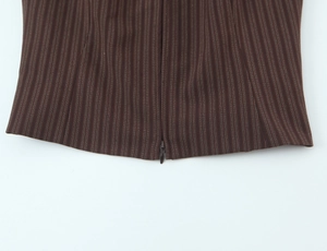 Close-up of invisible zipper and fine striped texture on dark brown fashion set